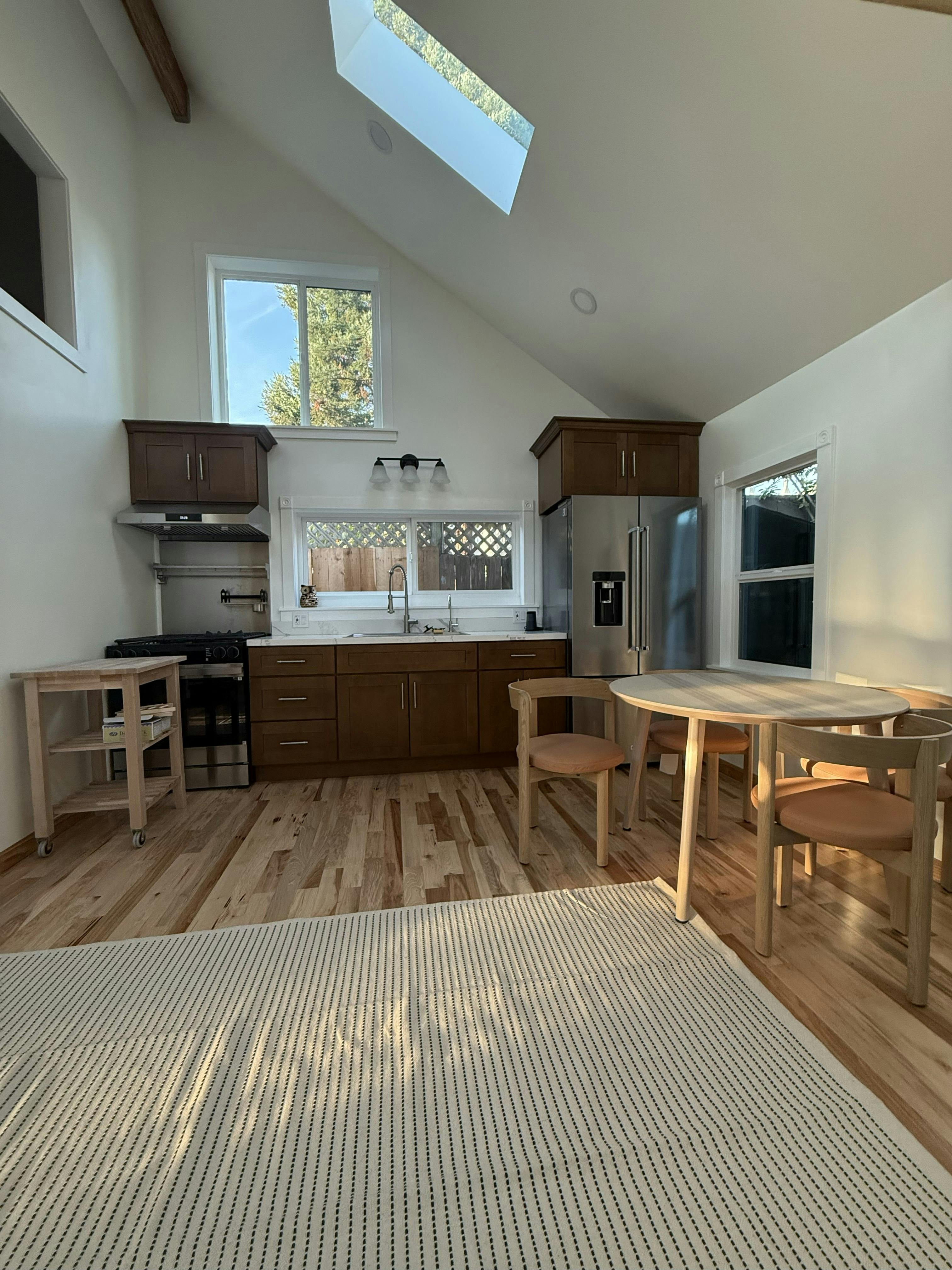 Kitchen with wood cabinets, stainless steel appliances, and a dining table