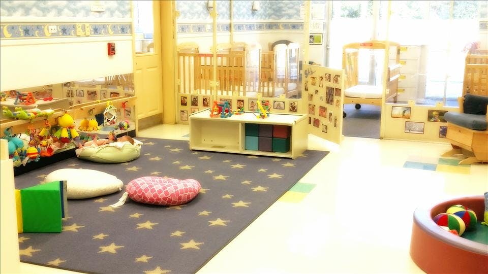 Classroom or daycare room for infants and toddlers with cribs and play area