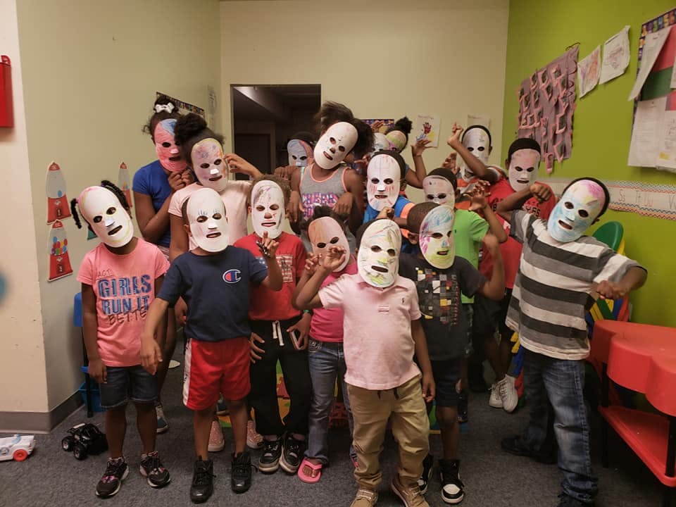 Group of children wearing white masks