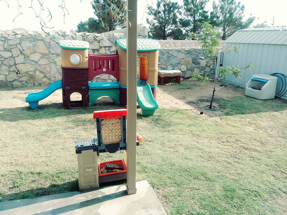 Children's playground equipment with slides and playhouse