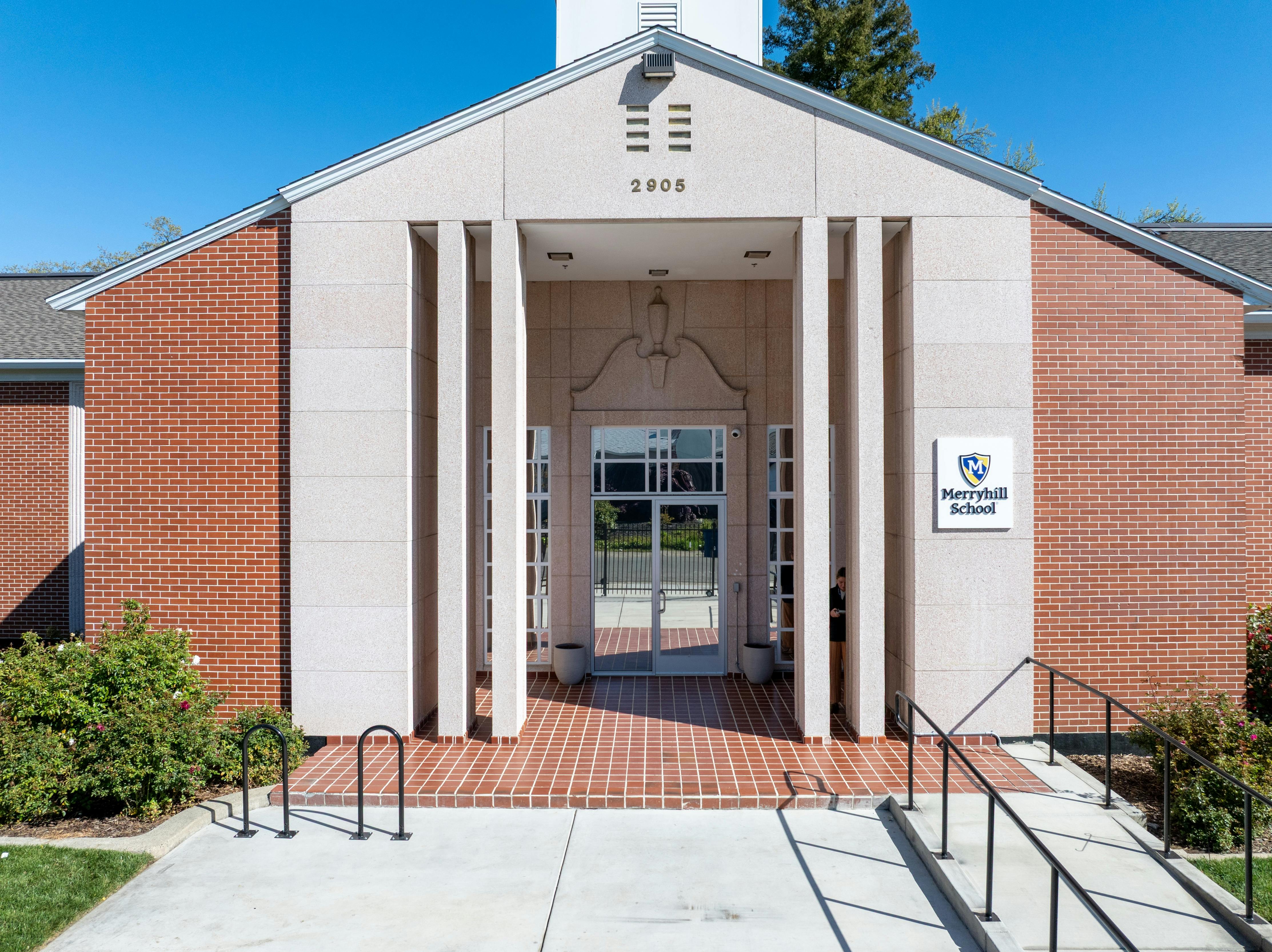 Front entrance of a brick building with a sign for "Haverhill School"