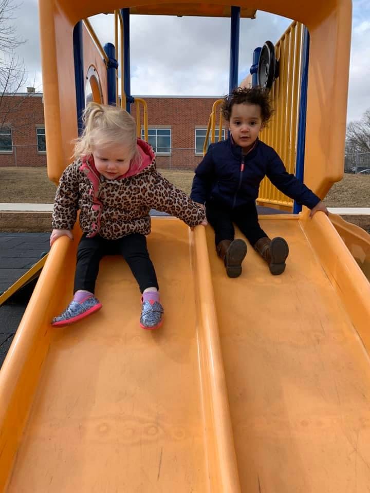 Two children sitting on a playground slide