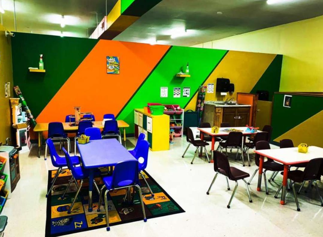 Classroom with colorful walls and small tables and chairs