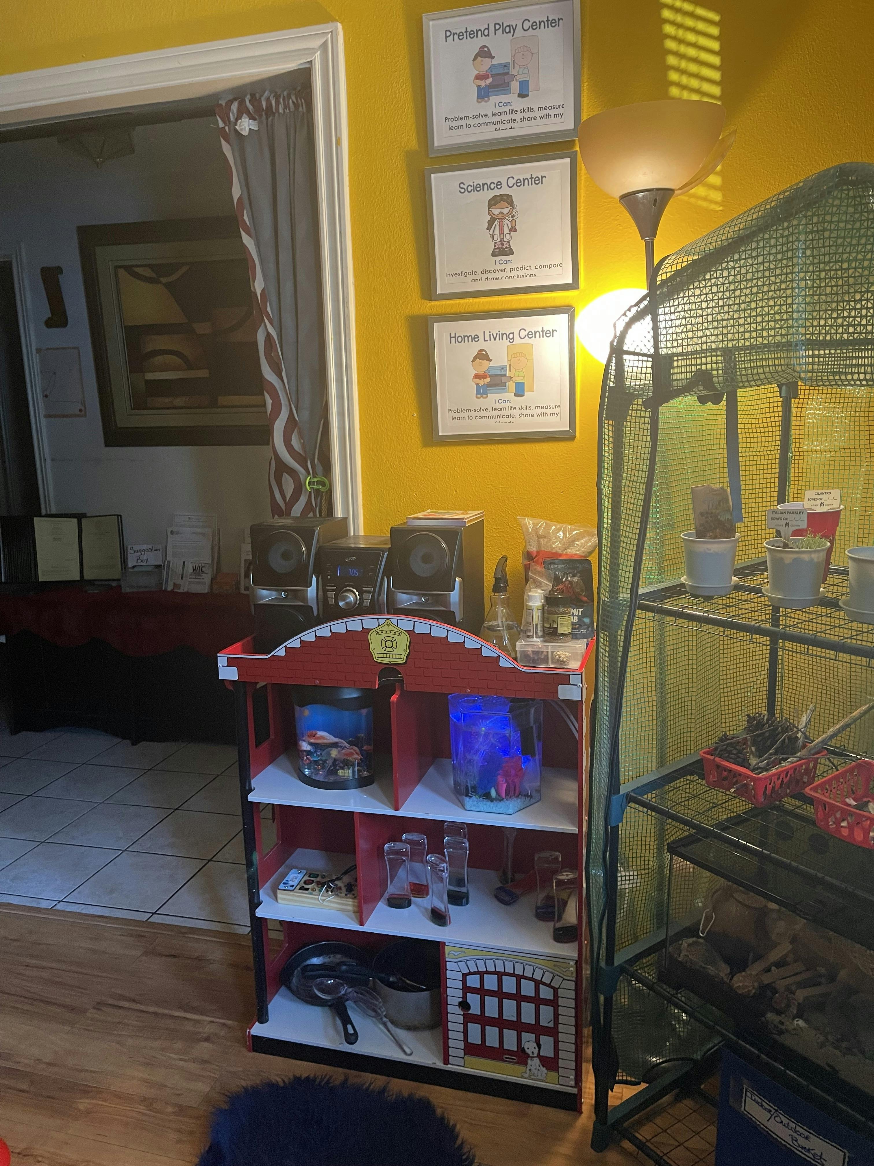Red and white toy shelf next to a metal shelving unit with plants