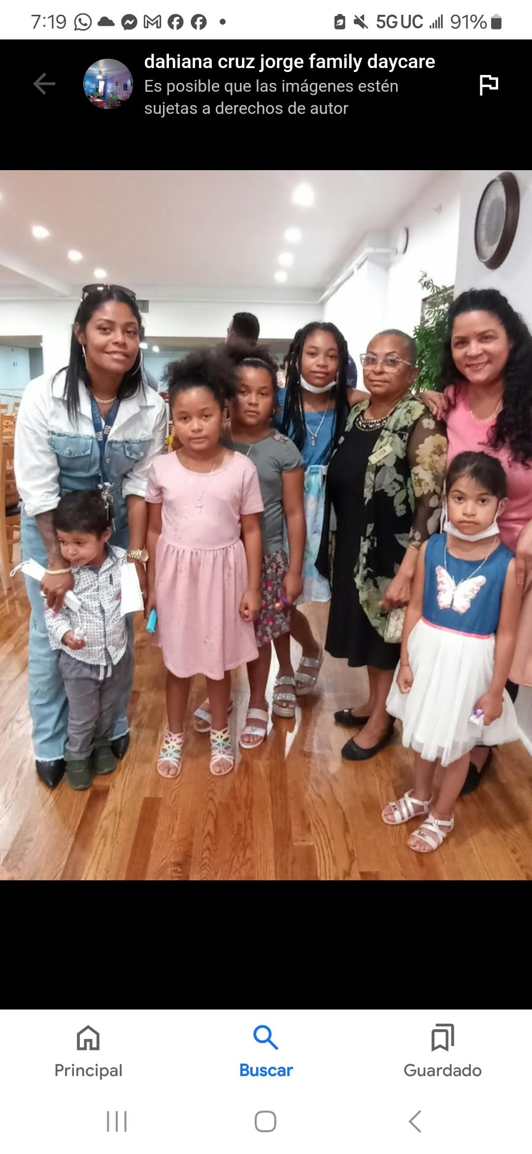 Group of adults and children standing together indoors