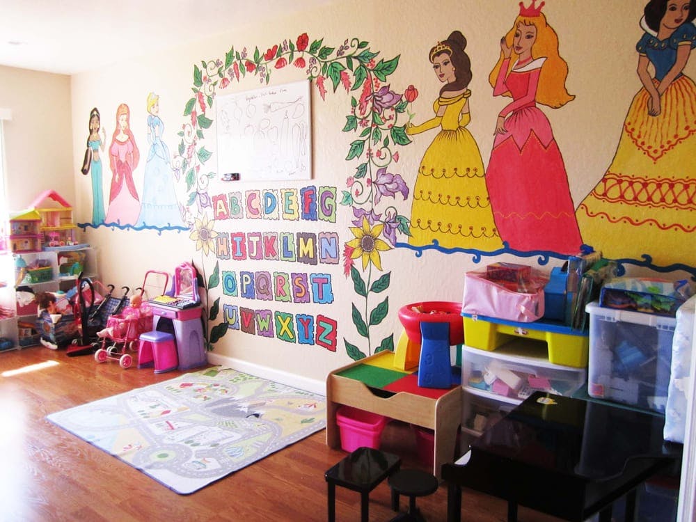 Playroom with princess murals, alphabet chart, and toys