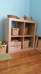 Wooden cube storage unit with baskets and drawers
