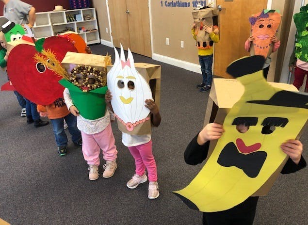 Children in costumes made from cardboard and fabric