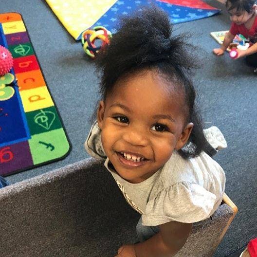 Child smiling in a classroom