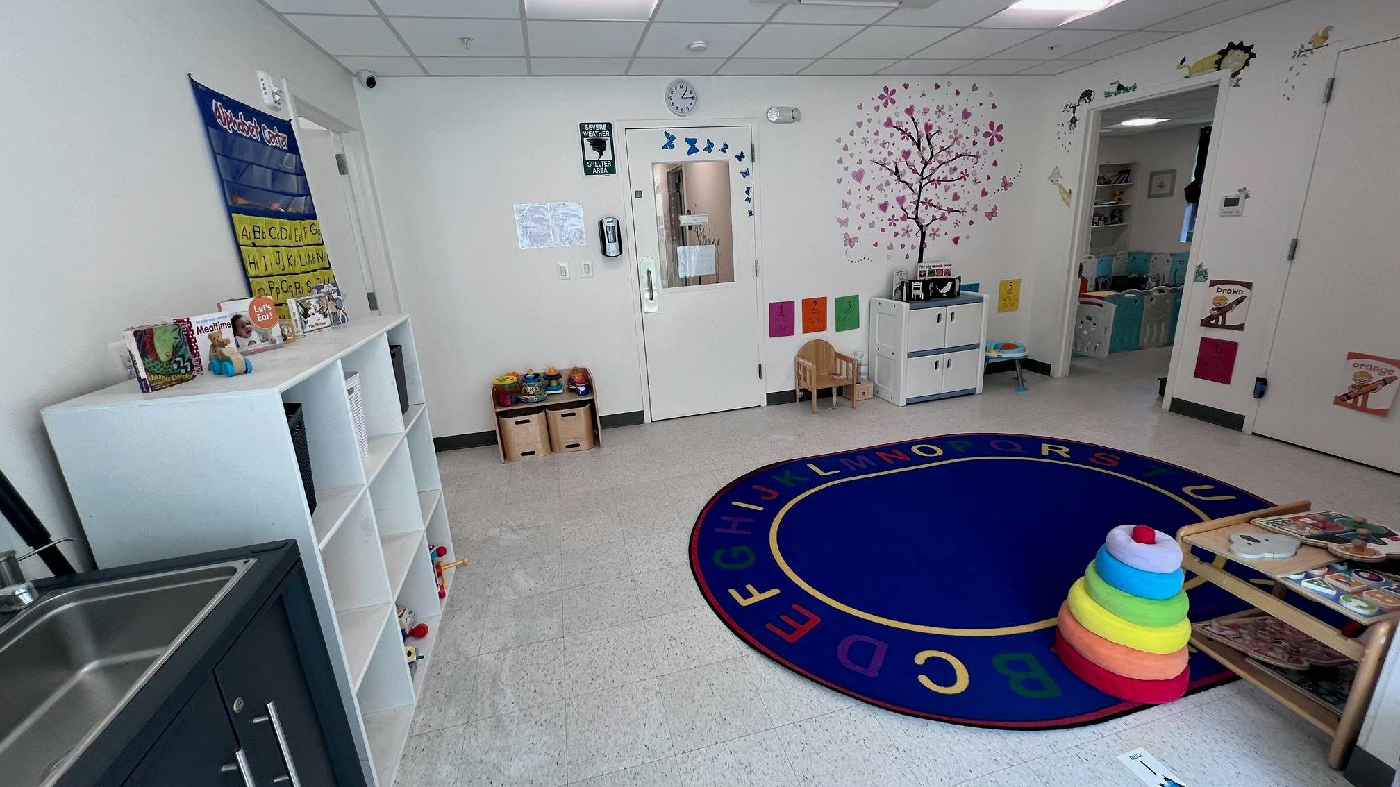 Colorful classroom with alphabet rug and learning materials