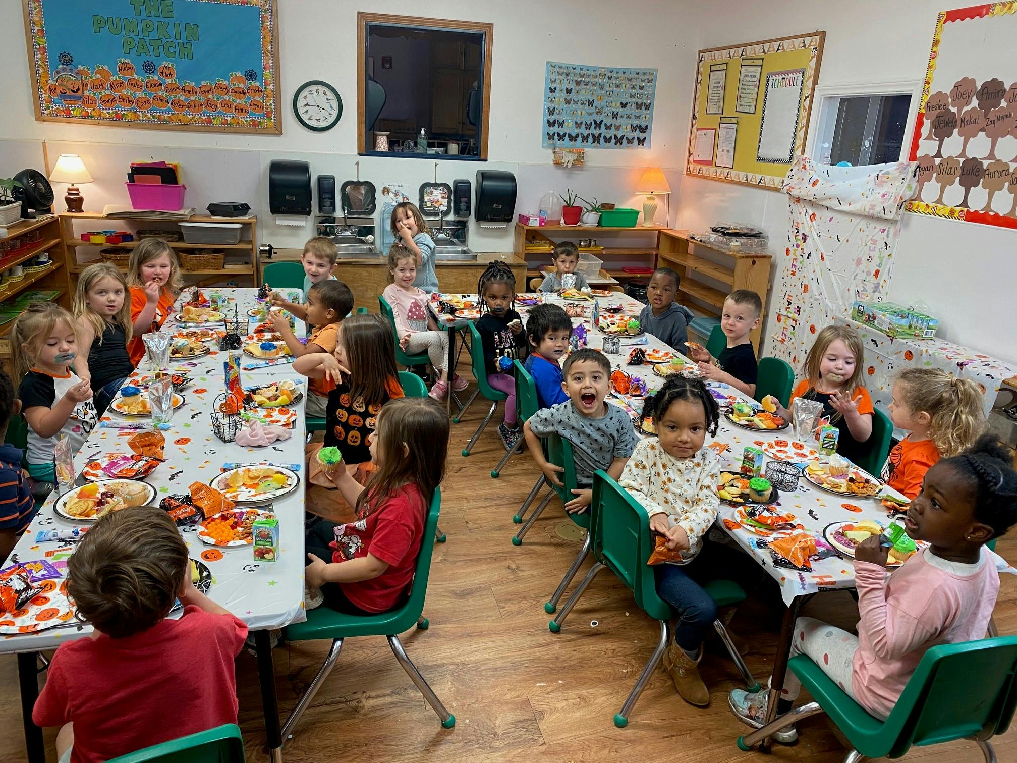 Children sitting at tables in a classroom