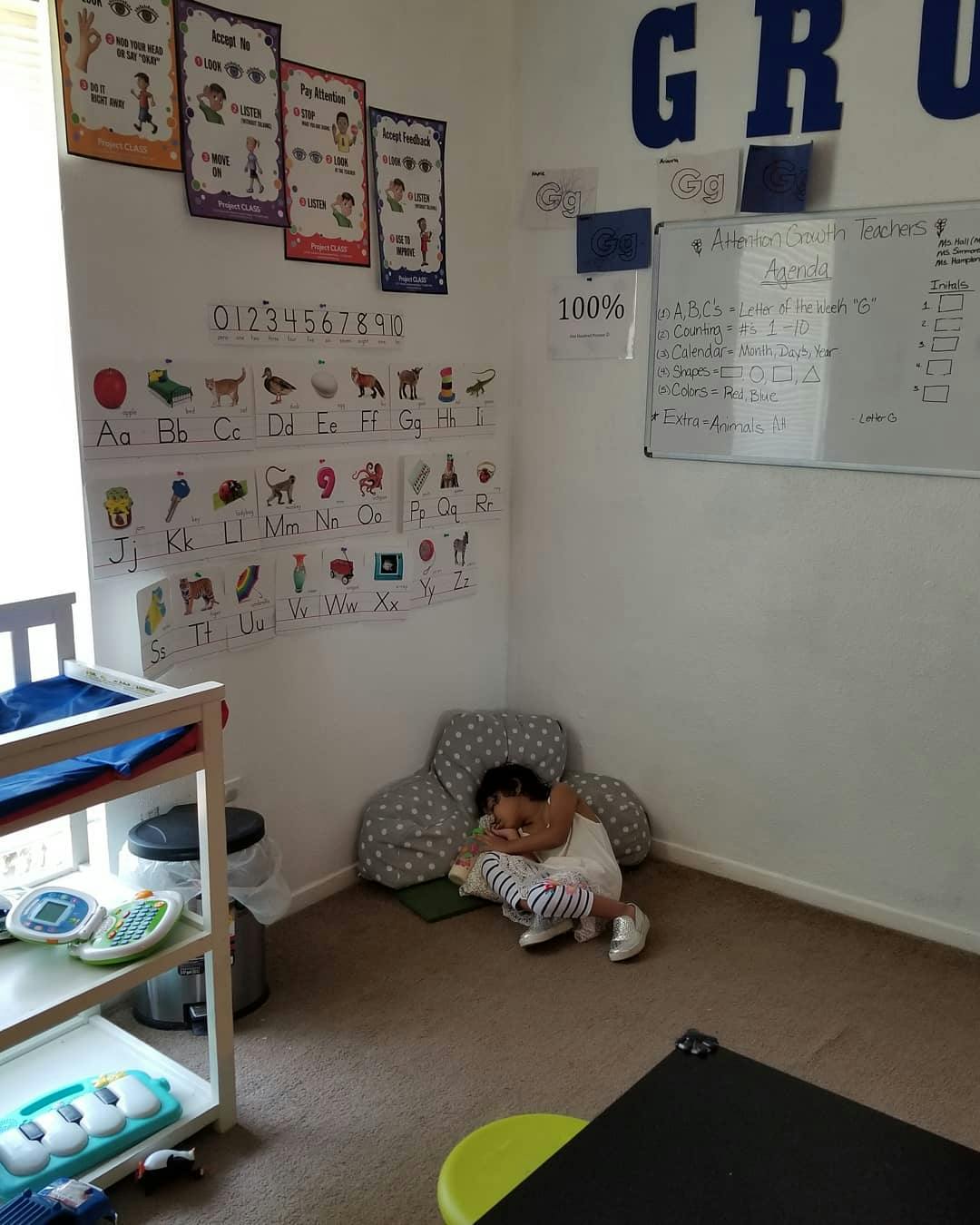 Child sitting on floor in a classroom