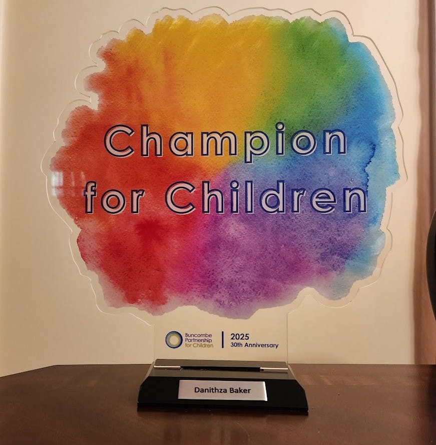 Acrylic award plaque labeled Champion for Children awarded to Danithza Baker
