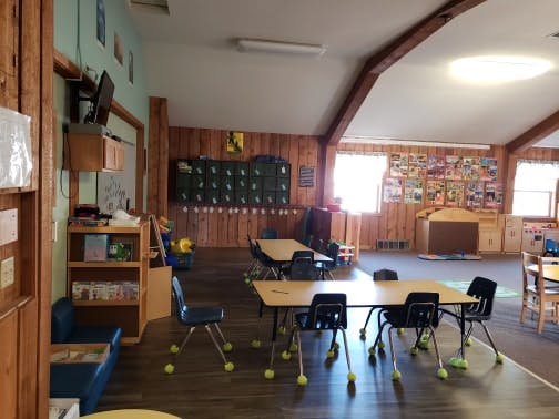 Empty classroom with small tables and chairs
