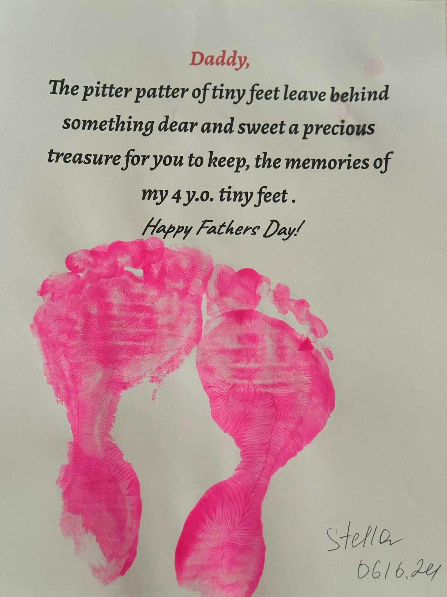 Pink footprints on a white paper with a handwritten message for Father's Day