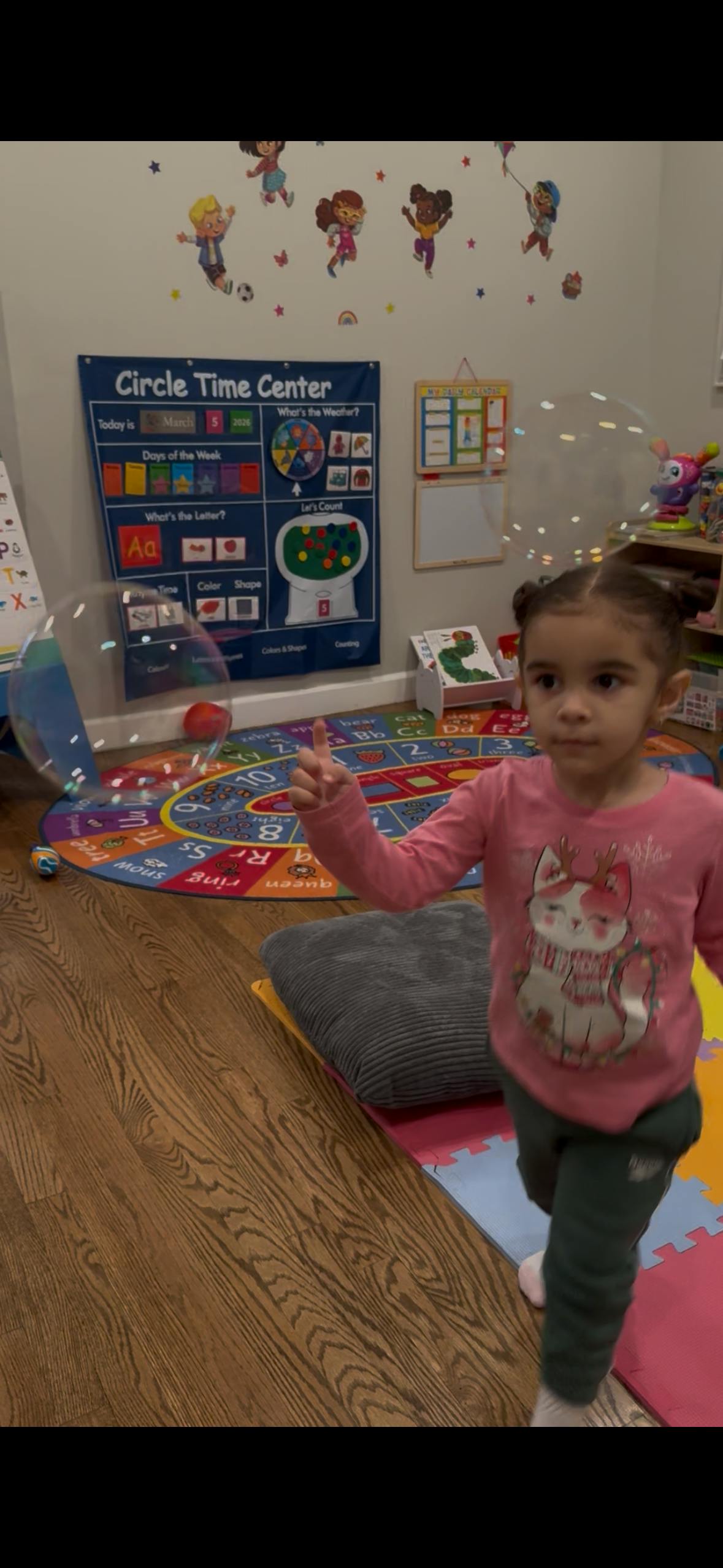 Child looking at bubbles in a classroom