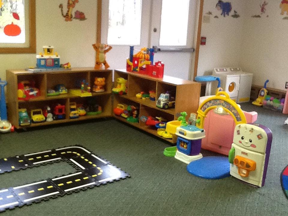 Playroom with toy shelves, play mat, and various toys