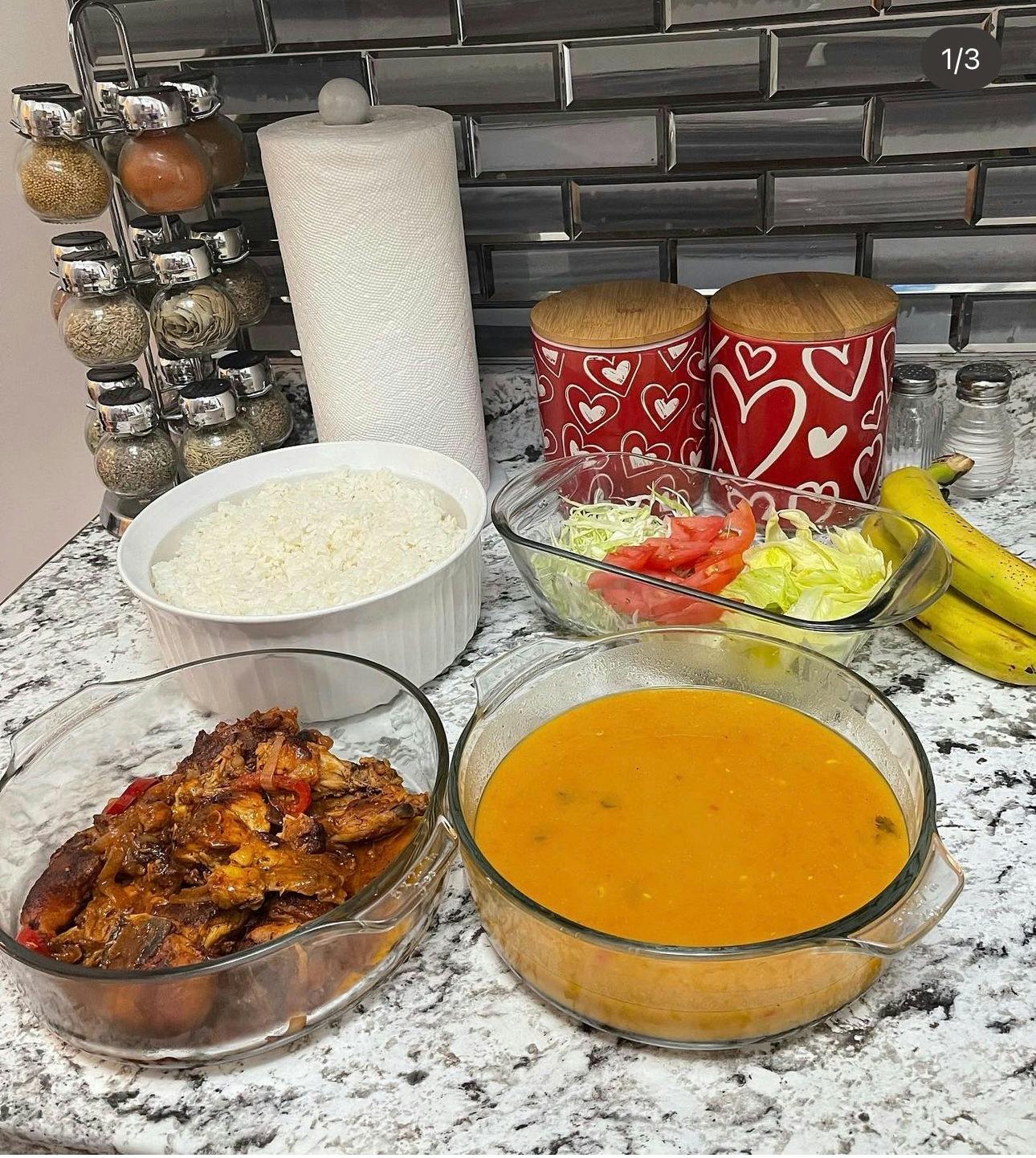 Bowls of rice, stew, soup, and salad on a counter