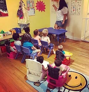 Person teaching children in a classroom