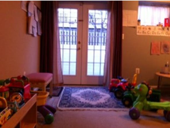 Playroom with toys and double doors leading outside