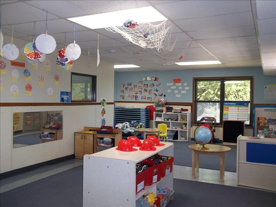 An empty classroom with various learning materials and decorations