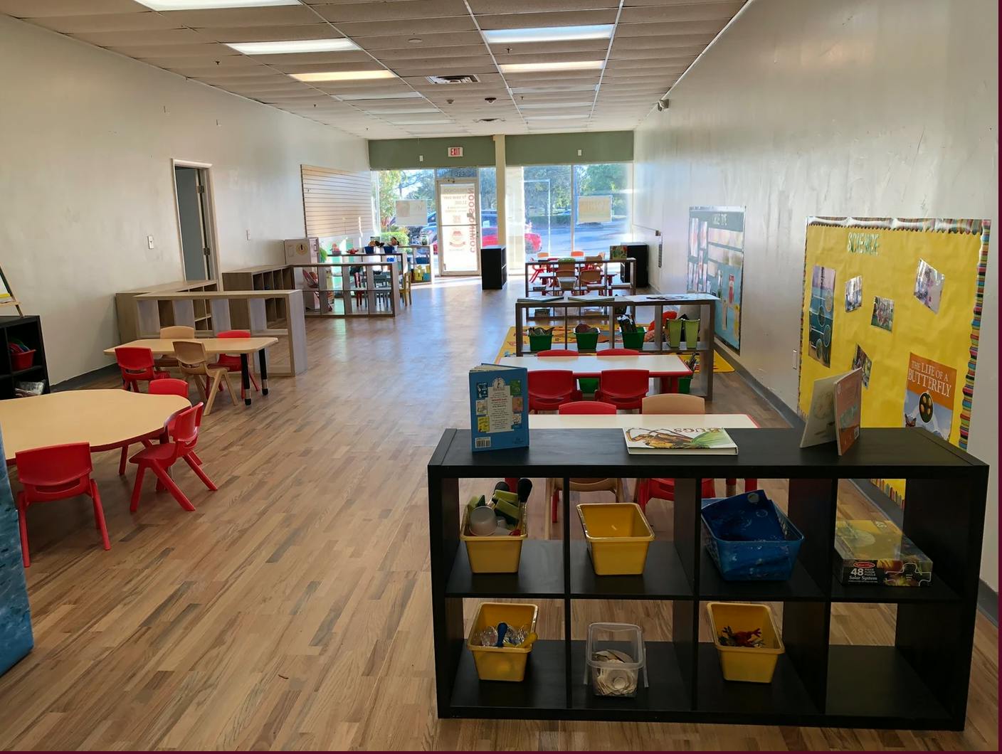 Empty classroom with small tables and chairs
