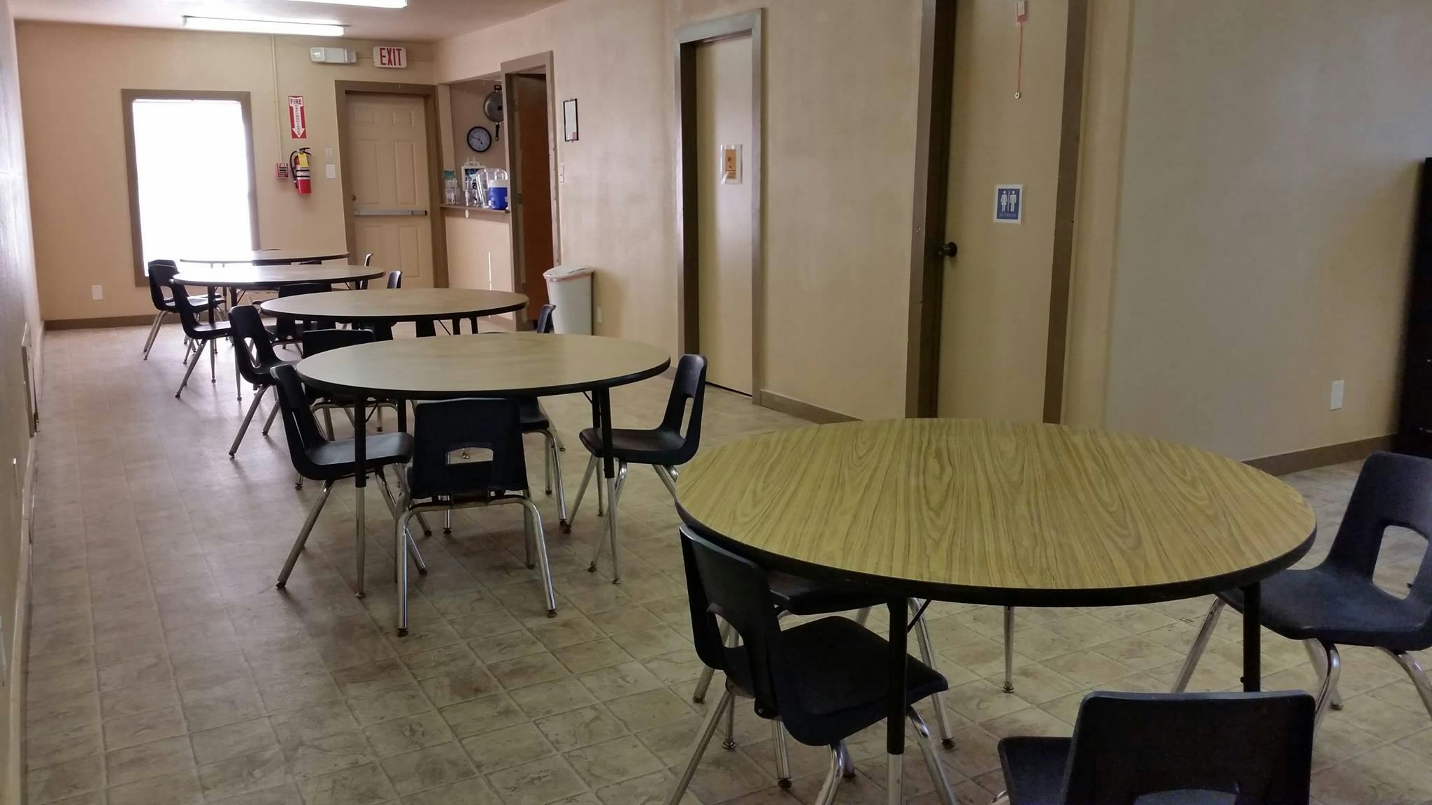 Empty room with multiple round tables and chairs