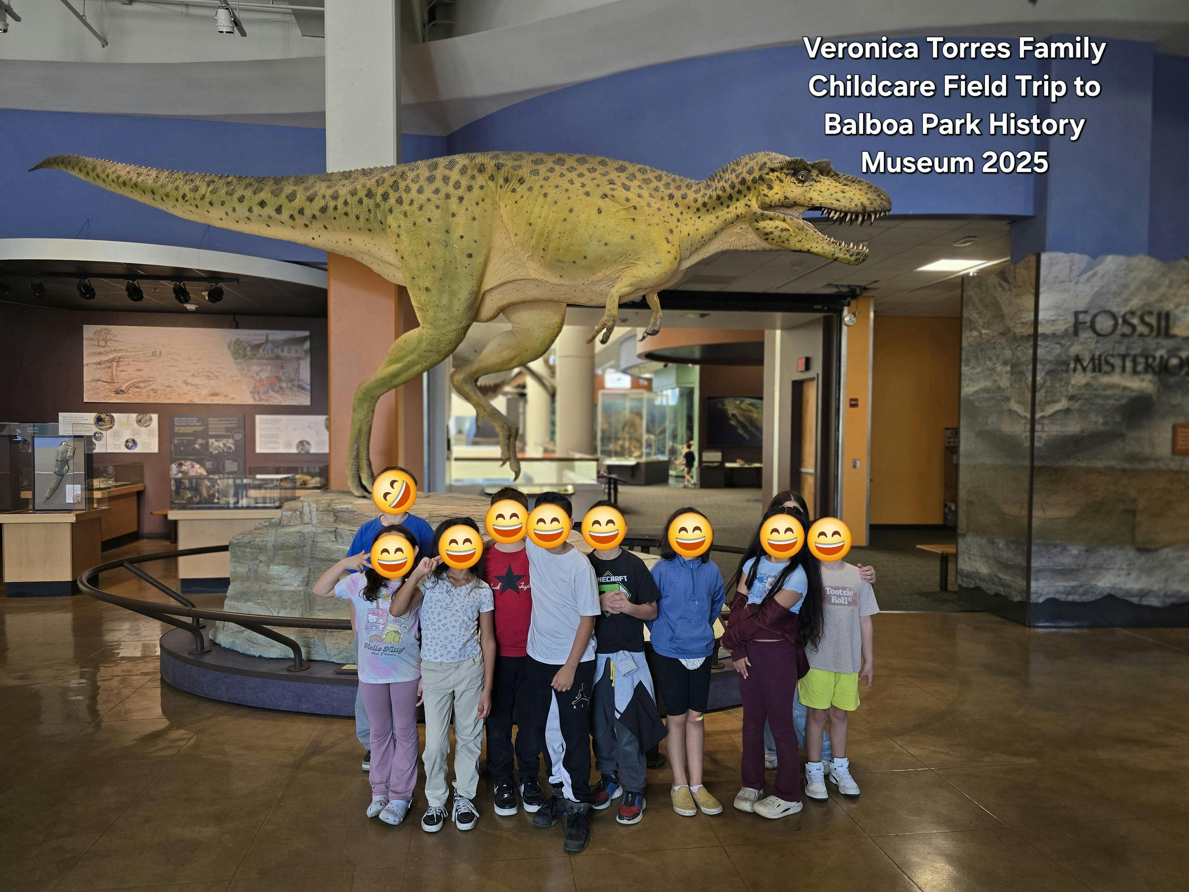 Group of children standing in front of a large dinosaur exhibit