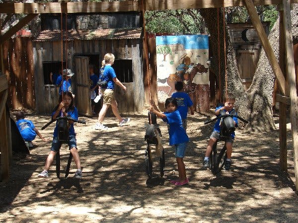 Children playing on stationary horse rides outdoors