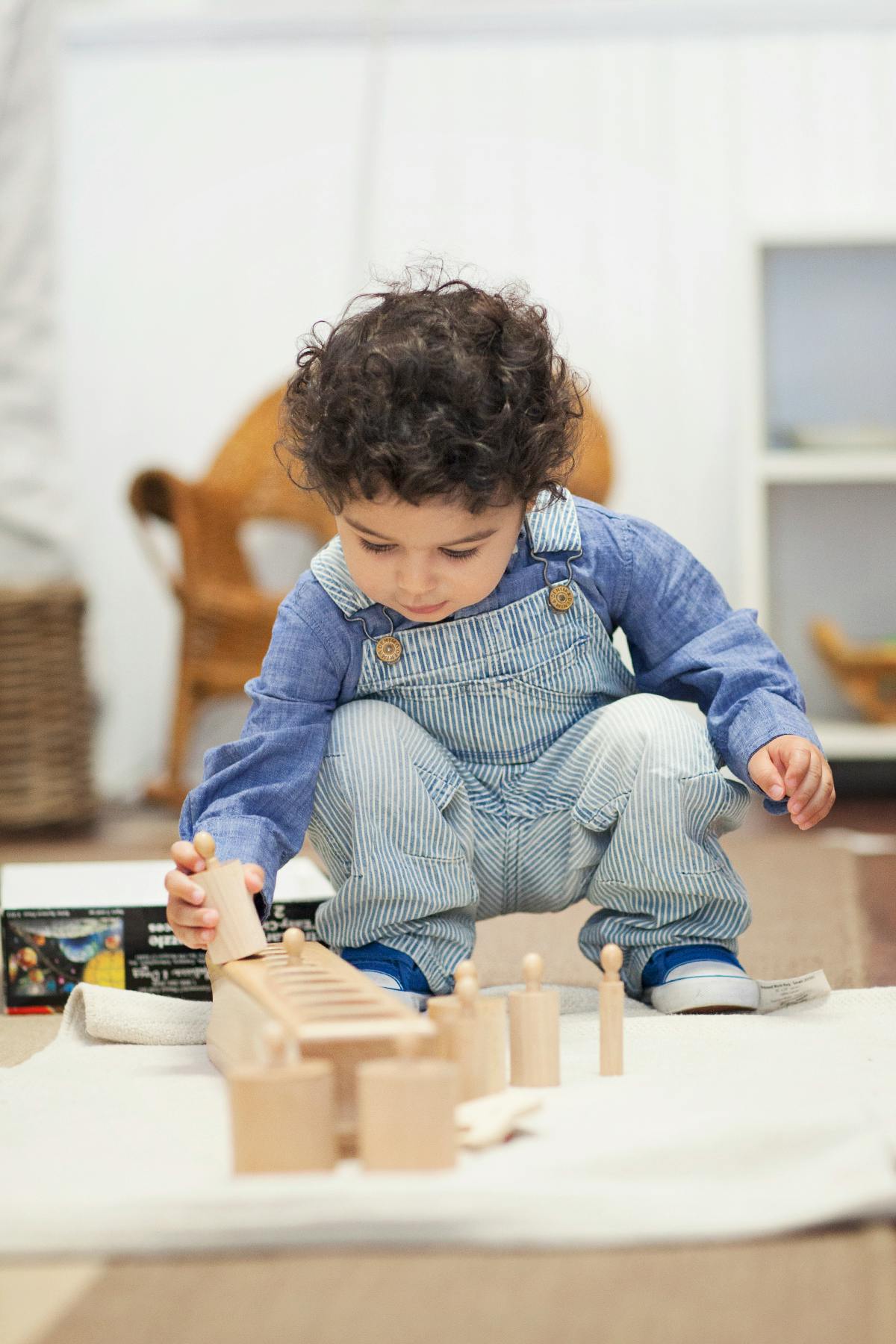 Child playing with wooden blocks on the floor
