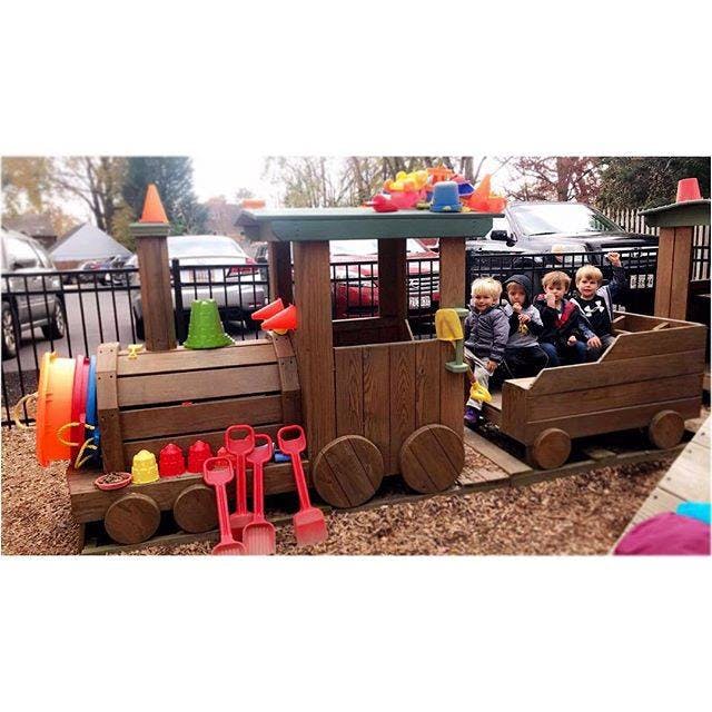 Children sitting in a wooden play train