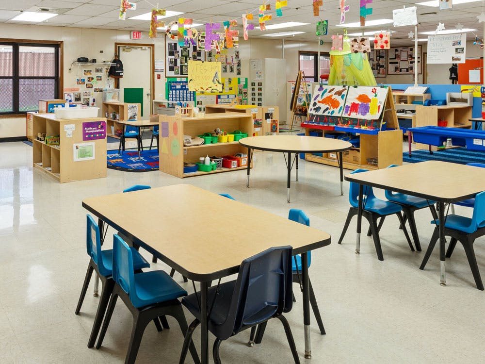 Empty classroom with small tables and chairs