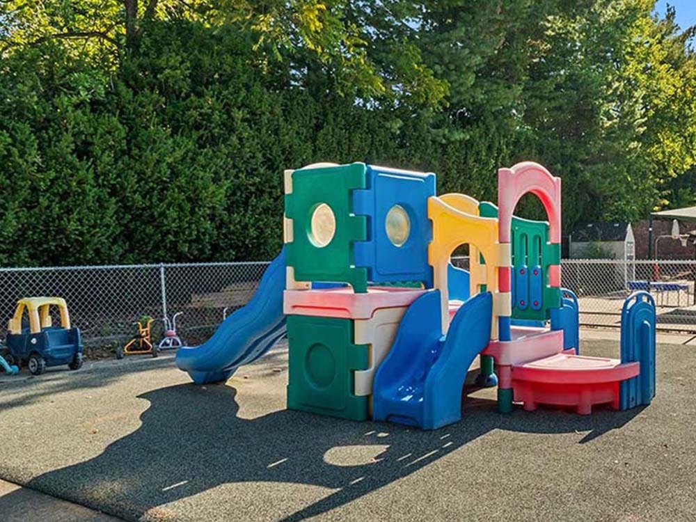 Colorful plastic play structure with slides on a playground