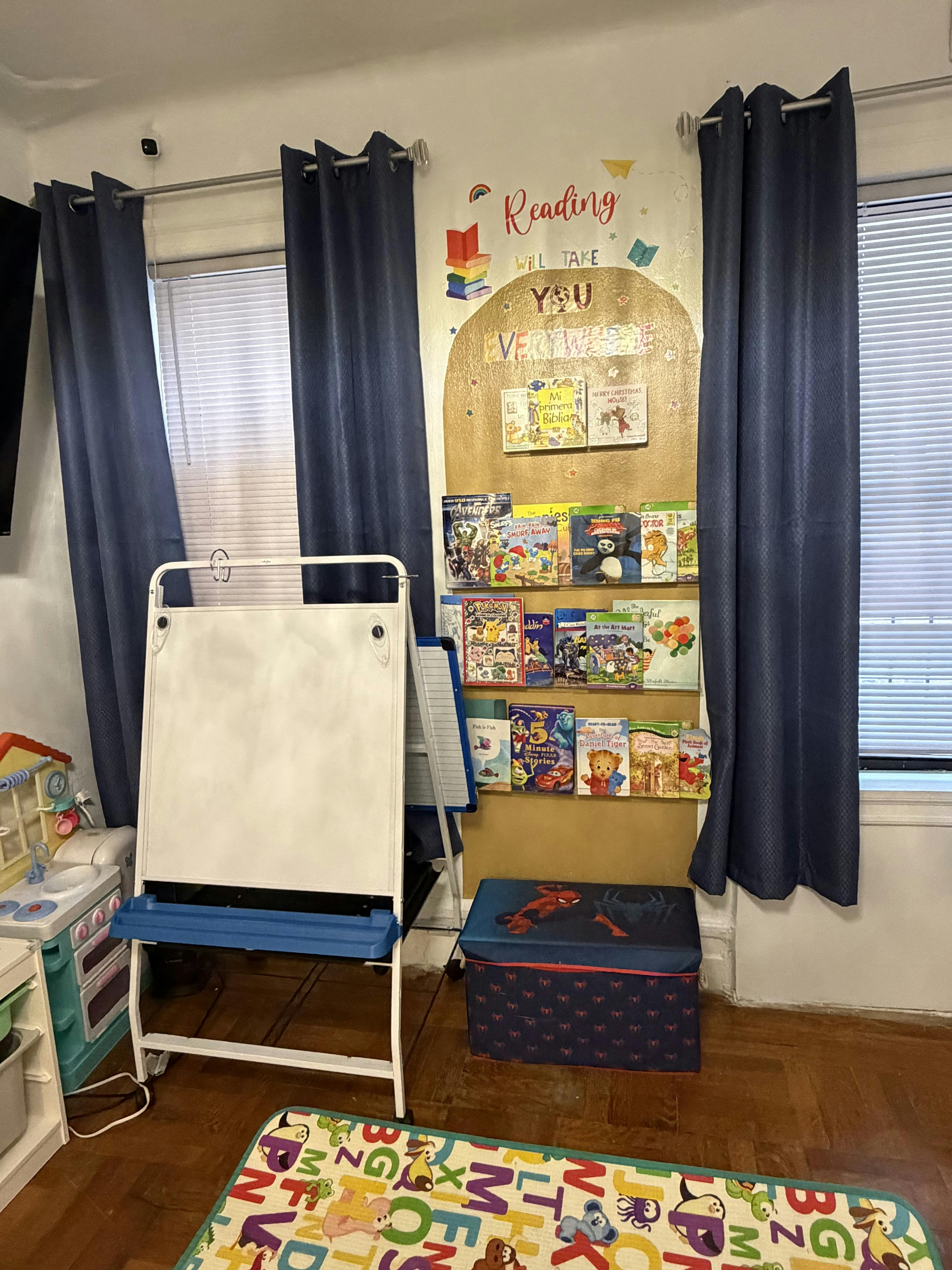 Children's room with a book display, an easel, and toy kitchen set