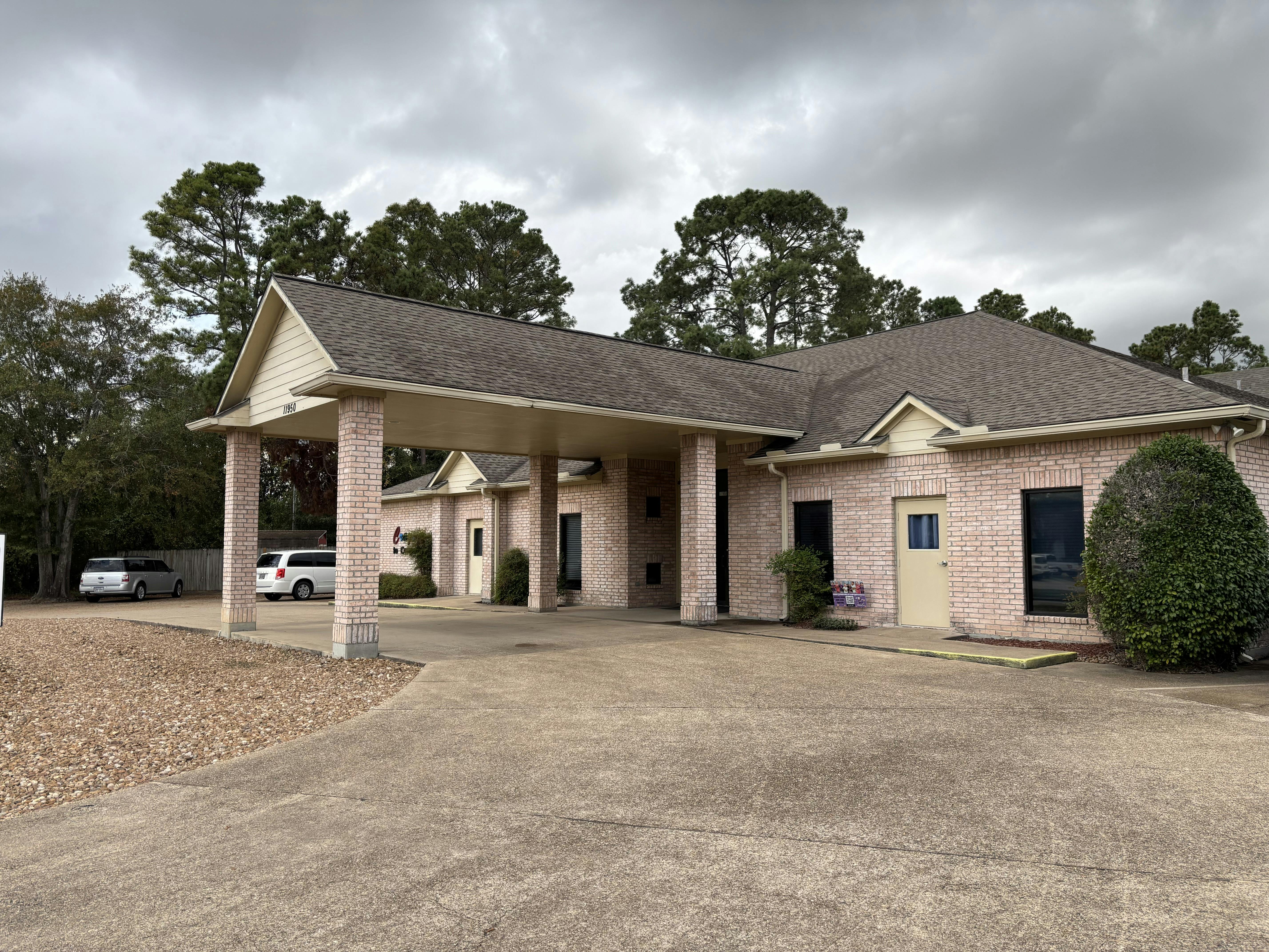 Building with a covered entrance and a parking area