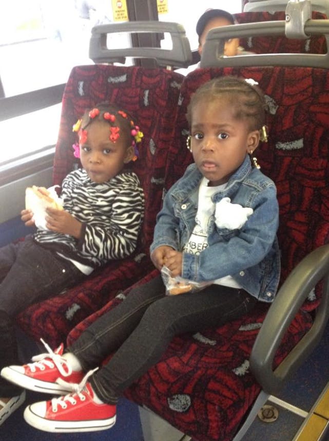 Two children sitting on bus seats