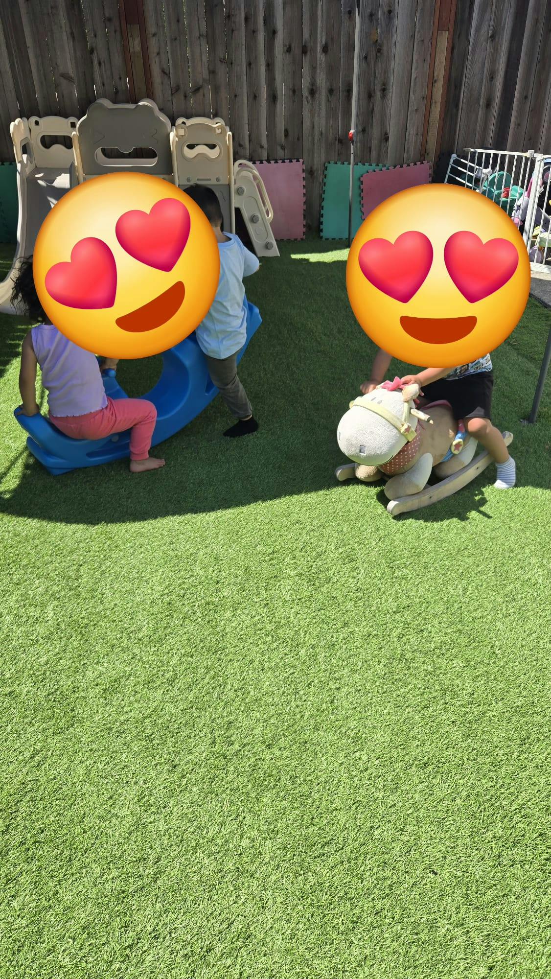 Children playing on a rocking toy and a seesaw