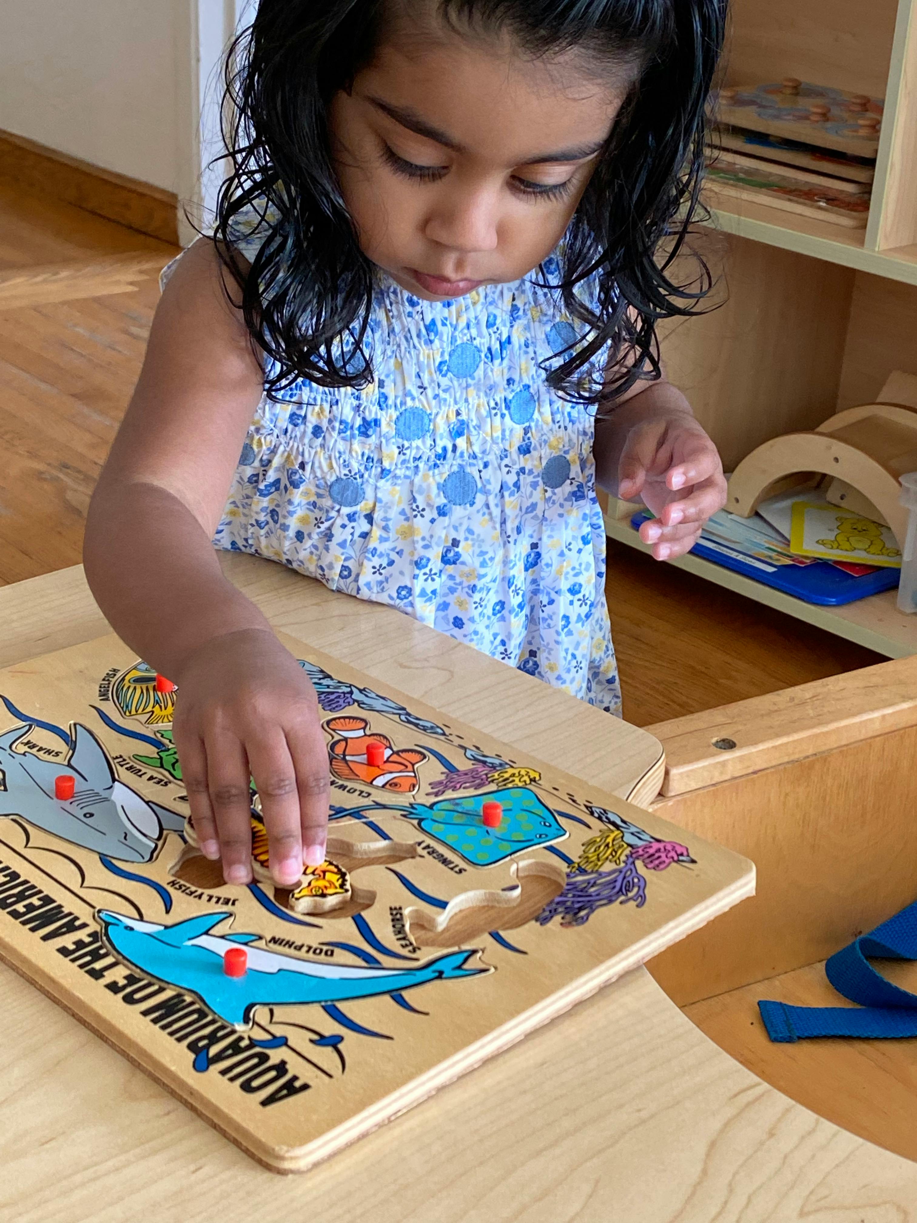 Child playing with a wooden puzzle
