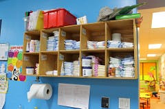 Shelves with diapers and other supplies in a room