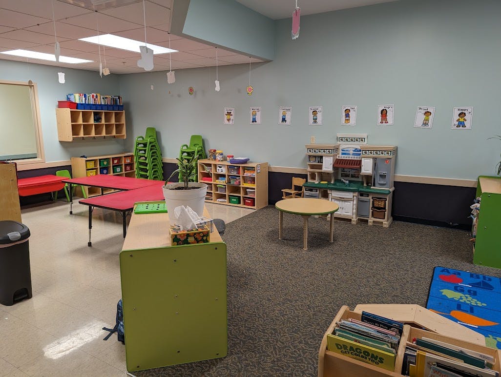 Classroom with tables, chairs, and storage shelves