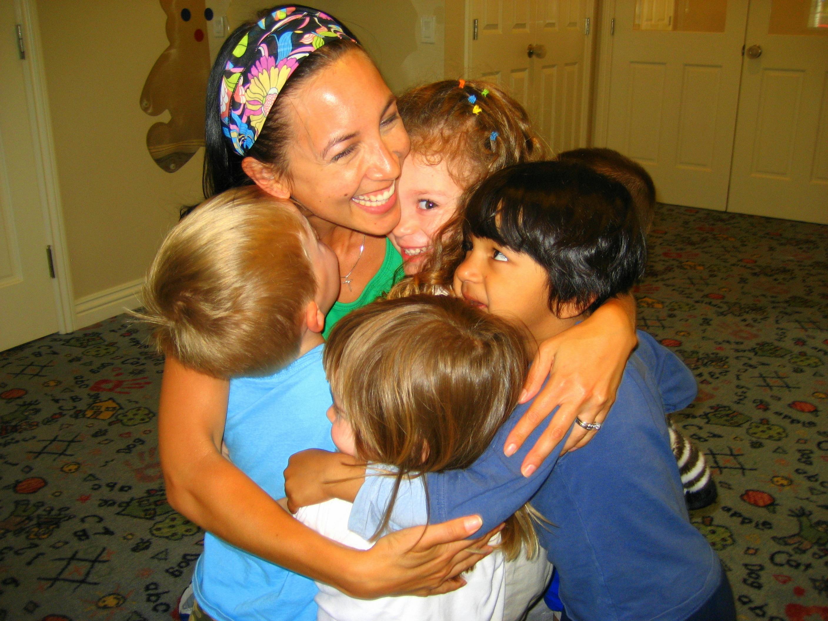 Person hugging multiple children
