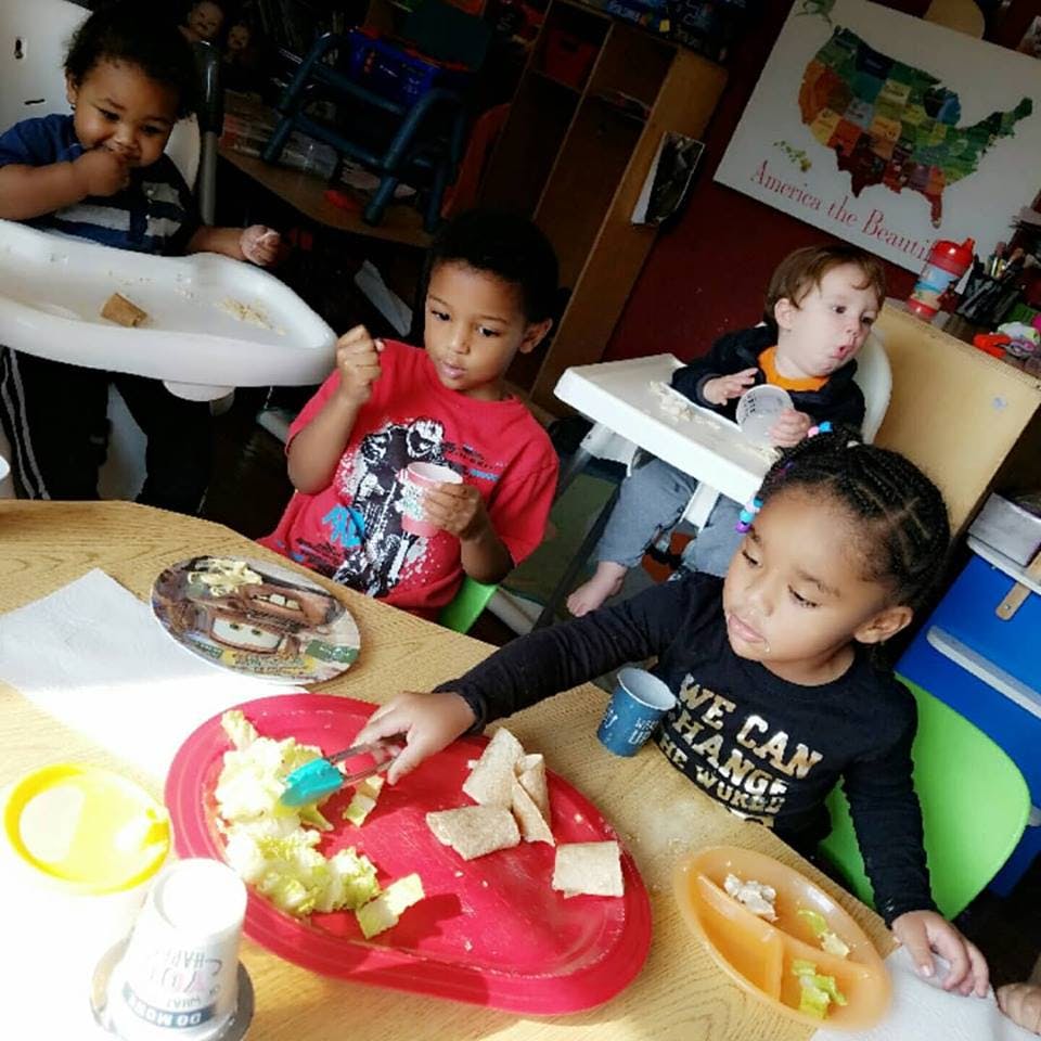 Four children eating at a table