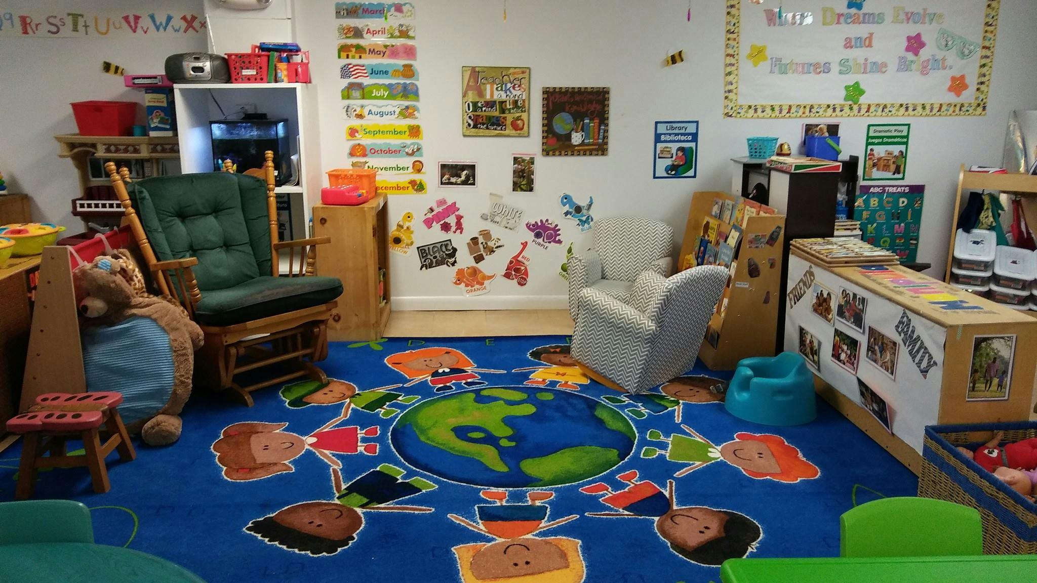 Classroom with a blue rug featuring a world map and diverse people