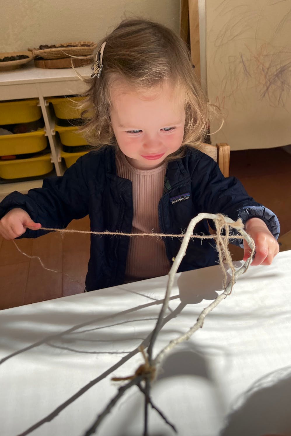Child holding string attached to a branch