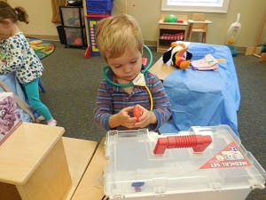 Child playing with a toy medical kit