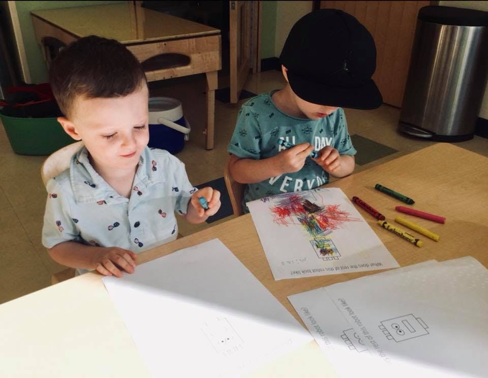 Two children coloring at a table