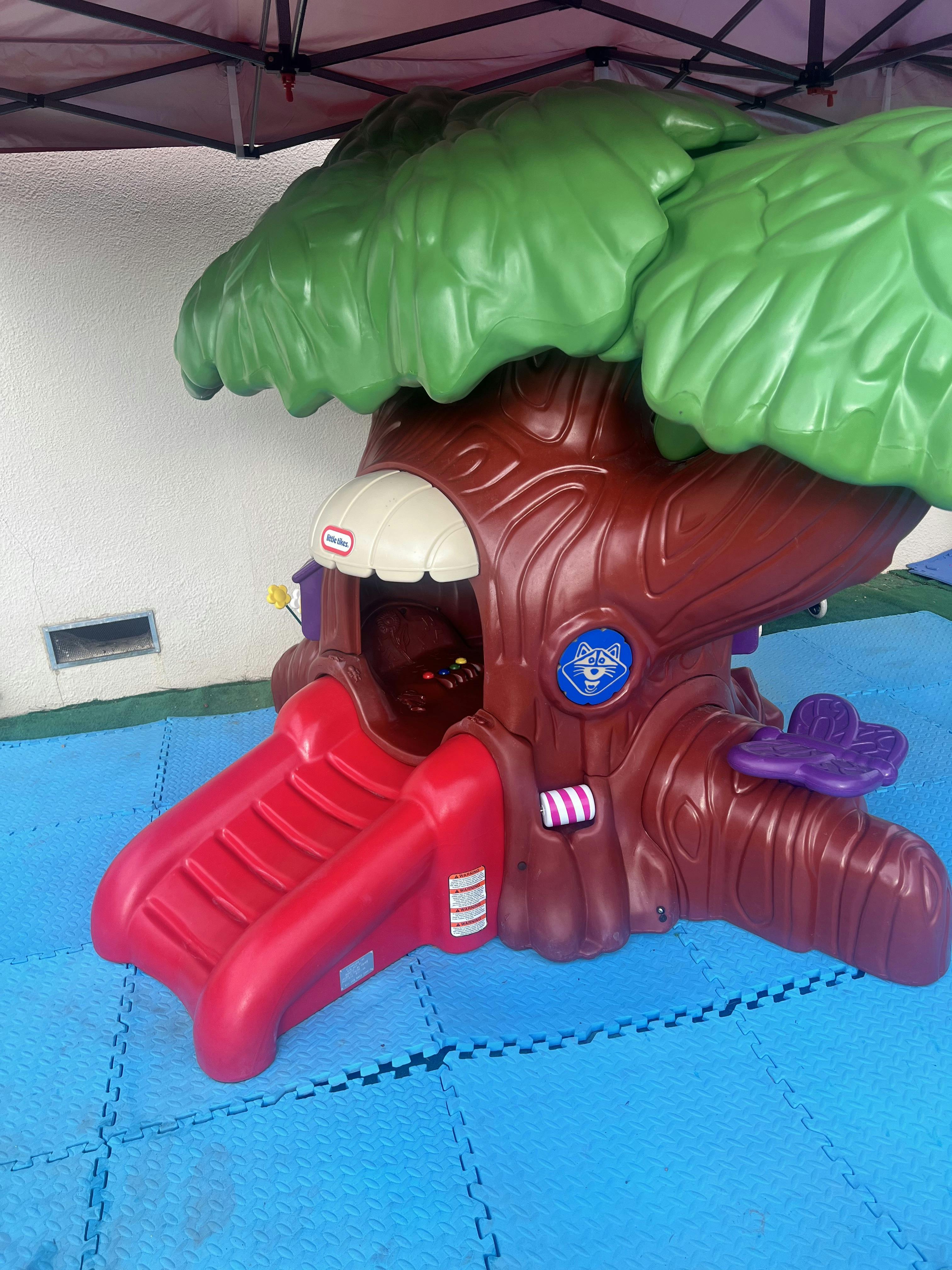 Plastic treehouse playground toy with a slide