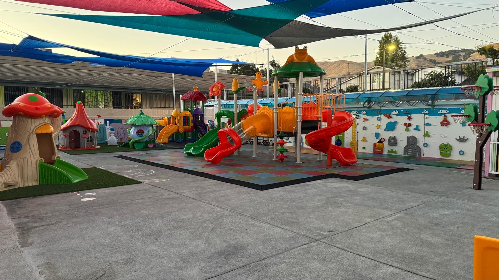 Colorful playground equipment under large sun shades