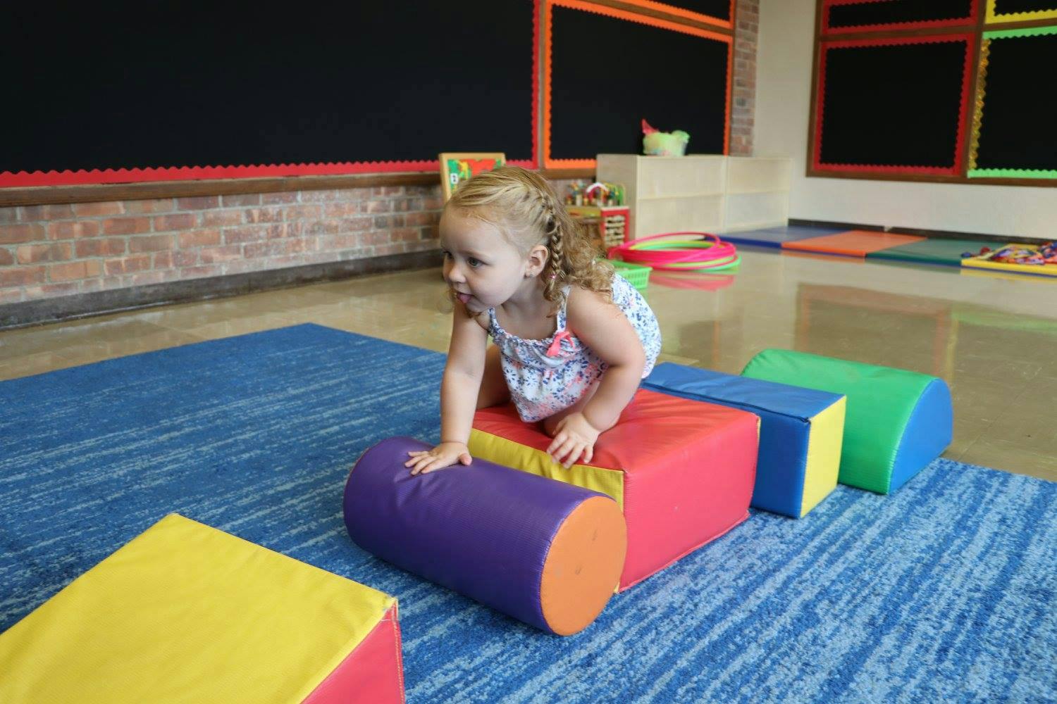 Child on colorful soft play equipment