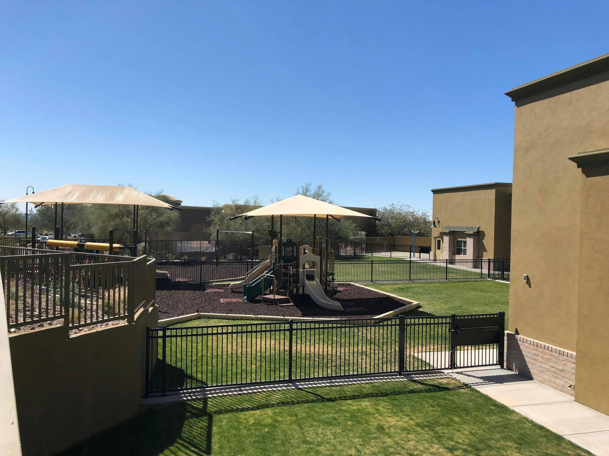 Outdoor playground with slides and shade structures